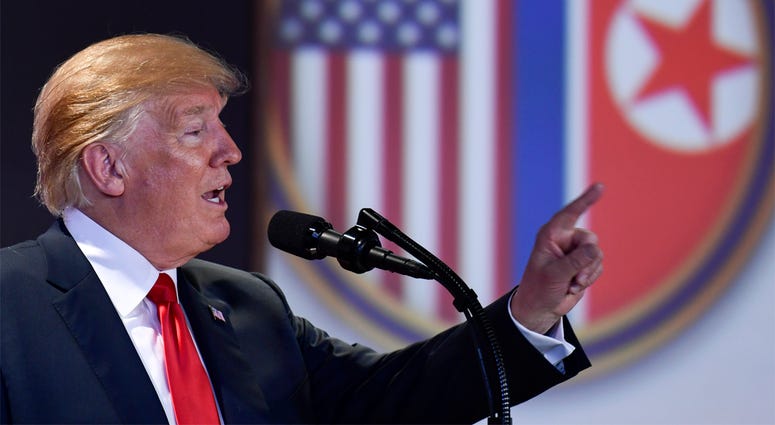 AP18163332842395 U.S. President Donald Trump answers questions about the summit with North Korea leader Kim Jong Un during a press conference at the Capella resort on Sentosa Island Tuesday, June 12, 2018 in Singapore. (AP Photo/Susan Walsh)