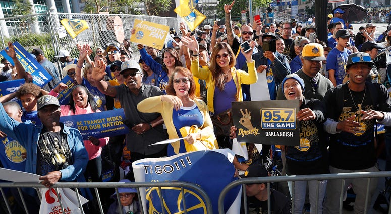 AP18163594509430 Fans wait for the parade to start in honor of the Golden State Warriors, Tuesday, June 12, 2018, in Oakland, Calif., to celebrate the team's NBA basketball championship. (AP Photo/Tony Avelar)