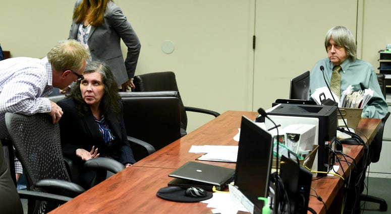 AP18170699740449 In this May 4, 2018, file photo, defendant Louise Anna Turpin, second left, talks with an investigator as her husband David Allen Turpin, right, looks on during a court appearance in Riverside, Calif. David and Louise Turpin are scheduled to appear for a