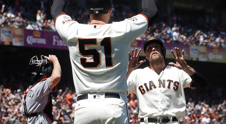 AP18171782741651 San Francisco Giants' Mac Williamson (51) celebrates with Hunter Pence, right, after both scored against the Miami Marlins during the sixth inning of a baseball game in San Francisco, Wednesday, June 20, 2018. Also pictured at left is Marlins catcher J.T.