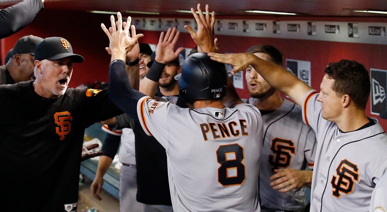 AP18182825138349 San Francisco Giants' Hunter Pence (8) celebrates his run scored against the Arizona Diamondbacks with assistant hitting coach Rick Schu, left, Austin Slater, second from right, and Nick Hundley, right, during the fifth inning of a baseball game Sunday, J