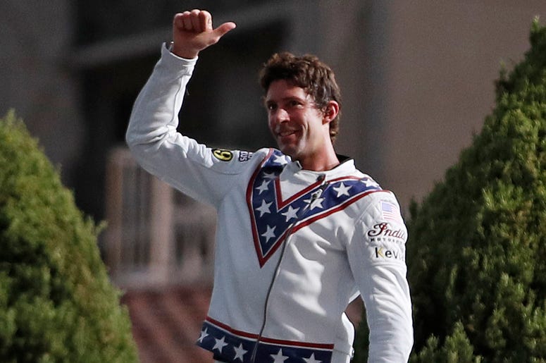 AP18190116067367 Travis Pastrana celebrates in the fountain at Caesars Palace after jumping it on a motorcycle Sunday, July 8, 2018, in Las Vegas. Pastrana recreated three of Evel Knievel's iconic motorcycle jumps on Sunday, including the leap over the fountains of Caesar