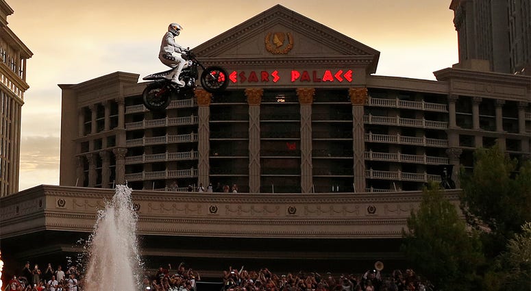 AP18190128593140 Travis Pastrana jumps the fountain at Caesars Palace on a motorcycle Sunday, July 8, 2018, in Las Vegas. Pastrana recreated three of Evel Knievel's iconic motorcycle jumps on Sunday, including the leap over the fountains of Caesars Palace that left Knieve