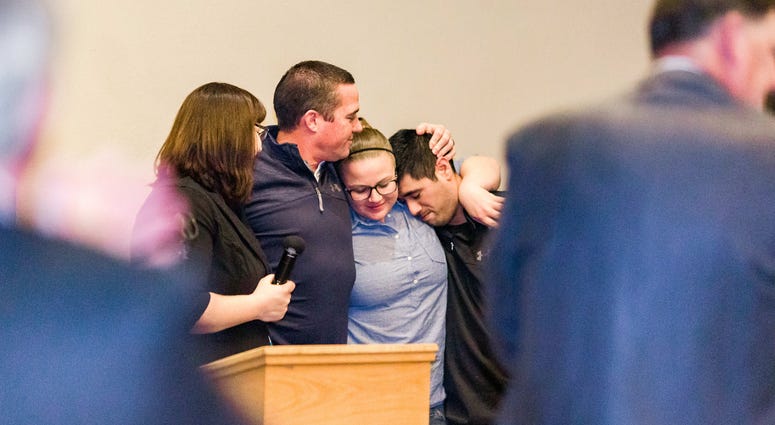 Paramedics Sean Abrams and Mike Castro and their EMT partners Shannon Molarius and Robin Cranston embrace at an event after the Camp Fire.