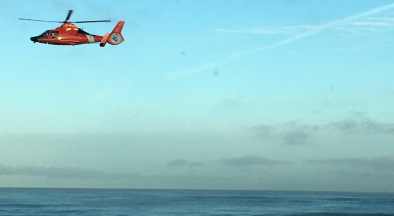 A helicopter flies above the Pacifica coastline, searching for a missing swimmer on March 26, 2019. A helicopter flies above the Pacifica coastline, searching for a missing swimmer on March 26, 2019.