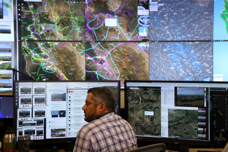 SAN FRANCISCO, CALIFORNIA - AUGUST 05: Pacific Gas and Electric (PG&E) Senior Wildfire Operations Center Analyst Anthony Malnati sits in front of video screens and computer monitors at he PG&E Wildfire Safety Operations Center in San Francisco, CA. SAN FRANCISCO, CALIFORNIA - AUGUST 05: Pacific Gas and Electric (PG&E) Senior Wildfire Operations Center Analyst Anthony Malnati sits in front of video screens and computer monitors at he PG&E Wildfire Safety Operations Center in San Francisco, CA.