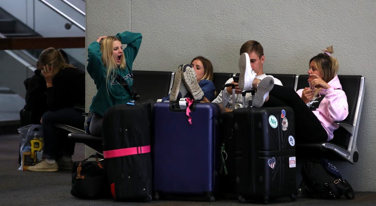Travelers sit on a bench at San Francisco International Airport on September 09, 2019 in San Francisco, California. Travelers sit on a bench at San Francisco International Airport on September 09, 2019 in San Francisco, California.