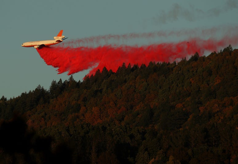 HEALDSBURG, CALIFORNIA - OCTOBER 29: A plane drops fire retardant ahead of the Kincade Fire on October 29, 2019 in Healdsburg, California. HEALDSBURG, CALIFORNIA - OCTOBER 29: A plane drops fire retardant ahead of the Kincade Fire on October 29, 2019 in Healdsburg, California.