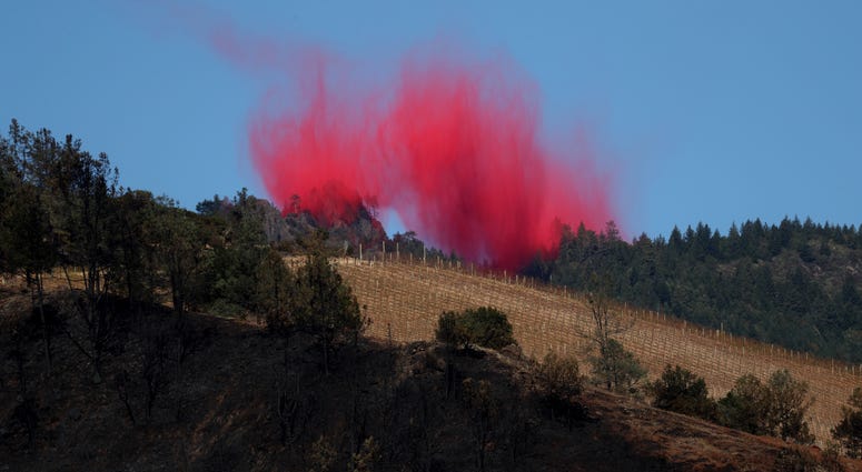 ire retardant lingers in the air after being dropped by a plane ahead of the Kincade Fire on October 29, 2019 in Healdsburg. ire retardant lingers in the air after being dropped by a plane ahead of the Kincade Fire on October 29, 2019 in Healdsburg.