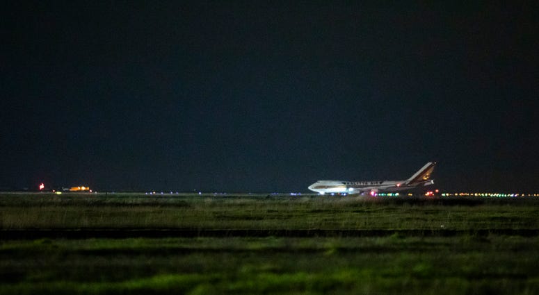A cargo aircraft chartered by the U.S. government arrives from Japan carrying American citizens being evacuated from the quarantined Diamond Princess cruise ship, at Travis Air Force Base on February 16, 2020. A cargo aircraft chartered by the U.S. government arrives from Japan carrying American citizens being evacuated from the quarantined Diamond Princess cruise ship, at Travis Air Force Base on February 16, 2020.