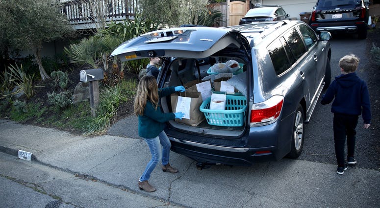 : Lelah Nichol, the wife David Nichol, the owner of Sociale, delivers meals with her two sons, Julian and Ellis, on March 27, 2020 in San Francisco. : Lelah Nichol, the wife David Nichol, the owner of Sociale, delivers meals with her two sons, Julian and Ellis, on March 27, 2020 in San Francisco.