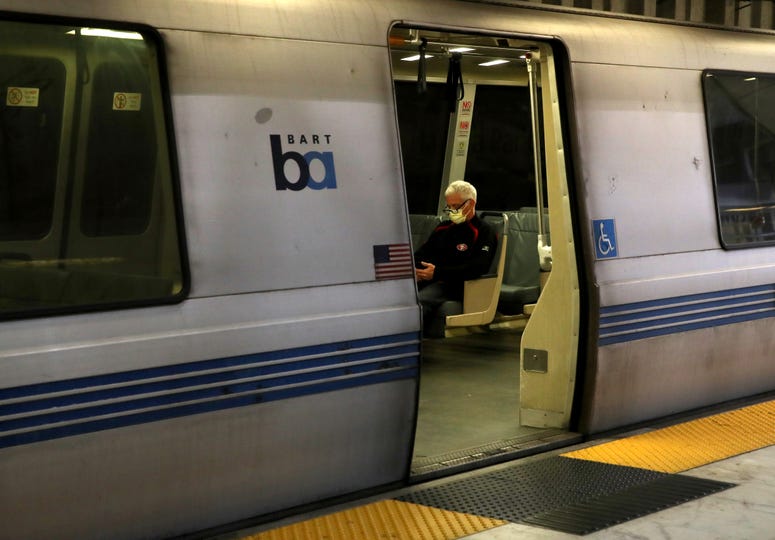 SAN FRANCISCO, CALIFORNIA - APRIL 08: A Bay Area Rapid Transit (BART) passenger rides in an empty train car on April 08, 2020 in San Francisco, California. SAN FRANCISCO, CALIFORNIA - APRIL 08: A Bay Area Rapid Transit (BART) passenger rides in an empty train car on April 08, 2020 in San Francisco, California.