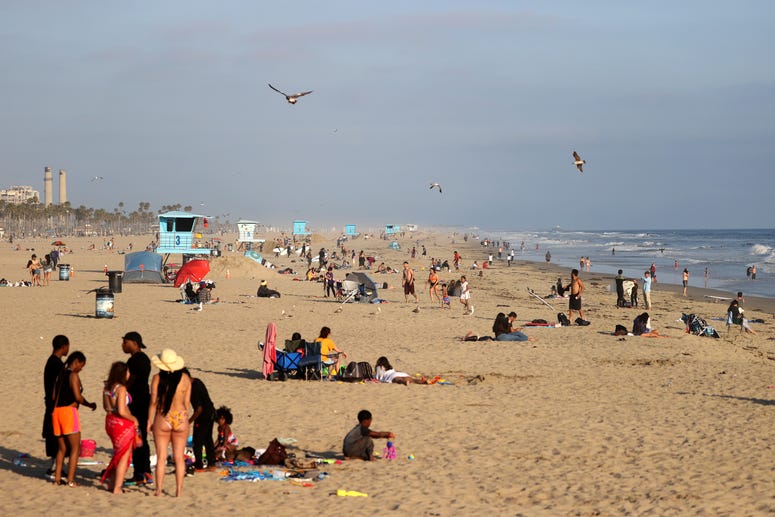 HUNTINGTON BEACH, CA - APRIL 30: People gather at the beach on April 30, 2020 in Huntington Beach, California. HUNTINGTON BEACH, CA - APRIL 30: People gather at the beach on April 30, 2020 in Huntington Beach, California.
