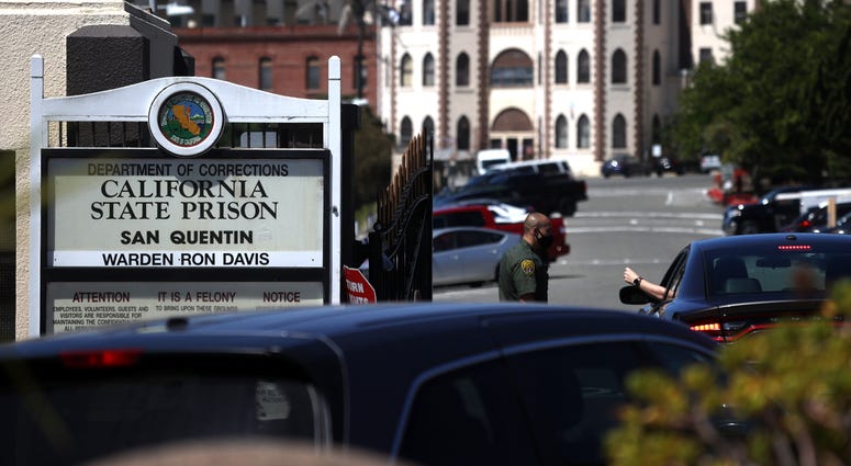 A California Department of Corrections and Rehabilitation (CDCR) officer wears a protective mask as he stands guard at the front gate of San Quentin State Prison on June 29, 2020 in San Quentin, California. A California Department of Corrections and Rehabilitation (CDCR) officer wears a protective mask as he stands guard at the front gate of San Quentin State Prison on June 29, 2020 in San Quentin, California.