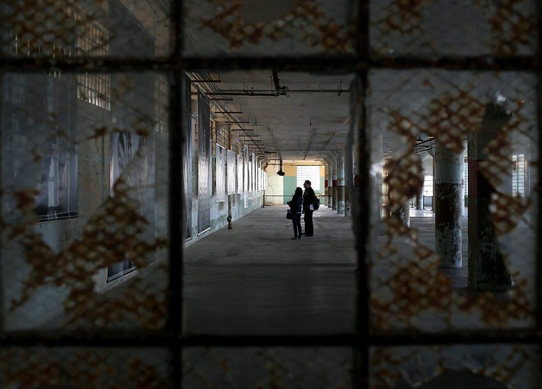 Reporters view an exhibit of photographs documenting the last day of Alcatraz federal penitentiary on March 21, 2013 in San Francisco, California. Reporters view an exhibit of photographs documenting the last day of Alcatraz federal penitentiary on March 21, 2013 in San Francisco, California.