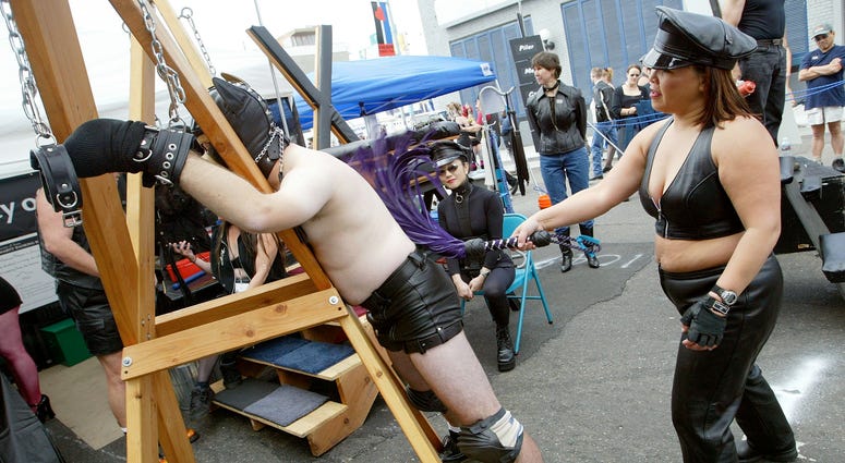 A man is whipped by a woman at the 20th Annual Folsom Street Fair September 28, 2003 in San Francisco, California. A man is whipped by a woman at the 20th Annual Folsom Street Fair September 28, 2003 in San Francisco, California.