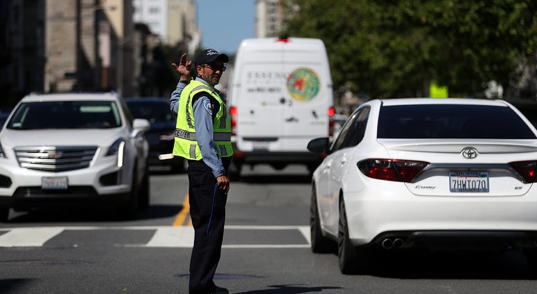 21: A San Francisco Municipal Transportation Agency officer directs traffic at an intersection with street lights out during a citywide power outage on April 21, 2017 in San Francisco, California. 21: A San Francisco Municipal Transportation Agency officer directs traffic at an intersection with street lights out during a citywide power outage on April 21, 2017 in San Francisco, California.