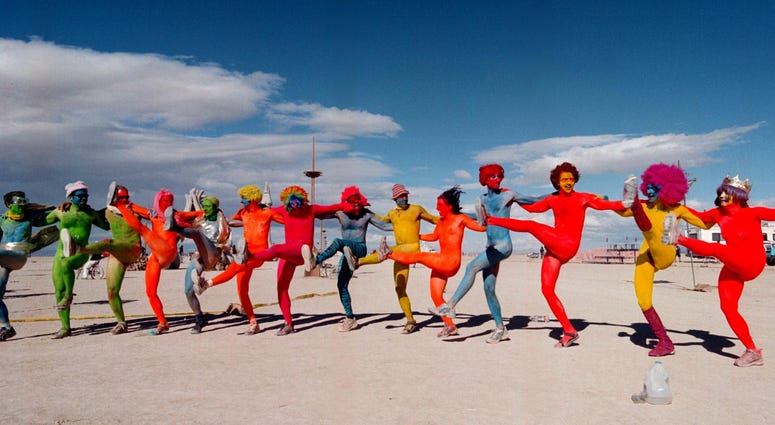 e "Painted People" of San Francisco and New York, dance while wearing only paint for clothing September 2, 2000 at the15th annual Burning Man festival in the Black Rock Desert near Gerlach, Nevada. e "Painted People" of San Francisco and New York, dance while wearing only paint for clothing September 2, 2000 at the15th annual Burning Man festival in the Black Rock Desert near Gerlach, Nevada.