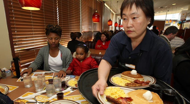 Denny's waitress Fong Van Luben (R) delivers free Grand Slam breakfasts to customers February 3, 2009 in Emeryville, California. Denny's waitress Fong Van Luben (R) delivers free Grand Slam breakfasts to customers February 3, 2009 in Emeryville, California.