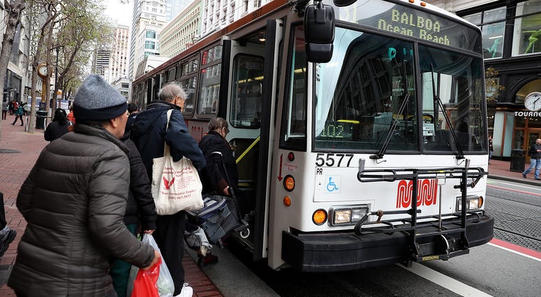 assengers board a MUNI bus on March 21, 2018 in San Francisco, California. assengers board a MUNI bus on March 21, 2018 in San Francisco, California.