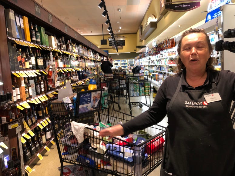 Safeway Bakery Manager Sherrie Blaine helps clean up in the supermarket after products fell from the shelves during a 4.5 magnitude earthquake on Oct. 14, 2019. Safeway Bakery Manager Sherrie Blaine helps clean up in the supermarket after products fell from the shelves during a 4.5 magnitude earthquake on Oct. 14, 2019.
