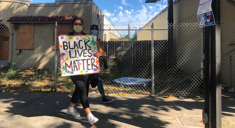 Protesters advance towards City Hall after blocking traffic in San Jose.