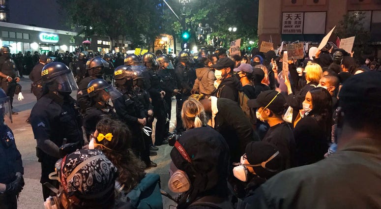 Protesters clash with police in Oakland.