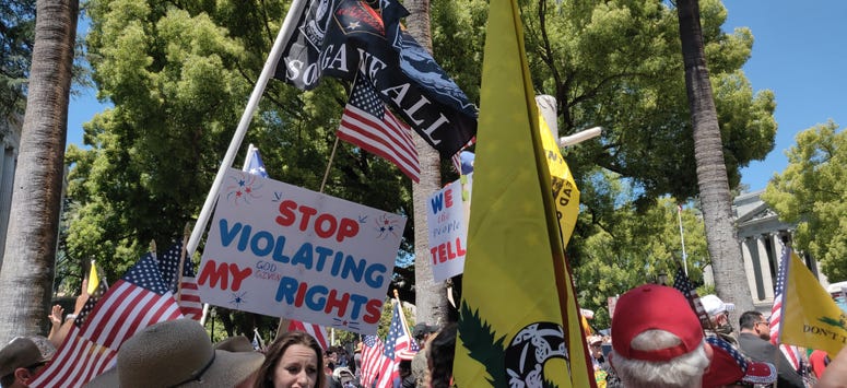 Protesters gather outside the State Capitol building in Sacramento at a rally against continued shelter-in-place orders and restrictions on businesses. Protesters gather outside the State Capitol building in Sacramento at a rally against continued shelter-in-place orders and restrictions on businesses.