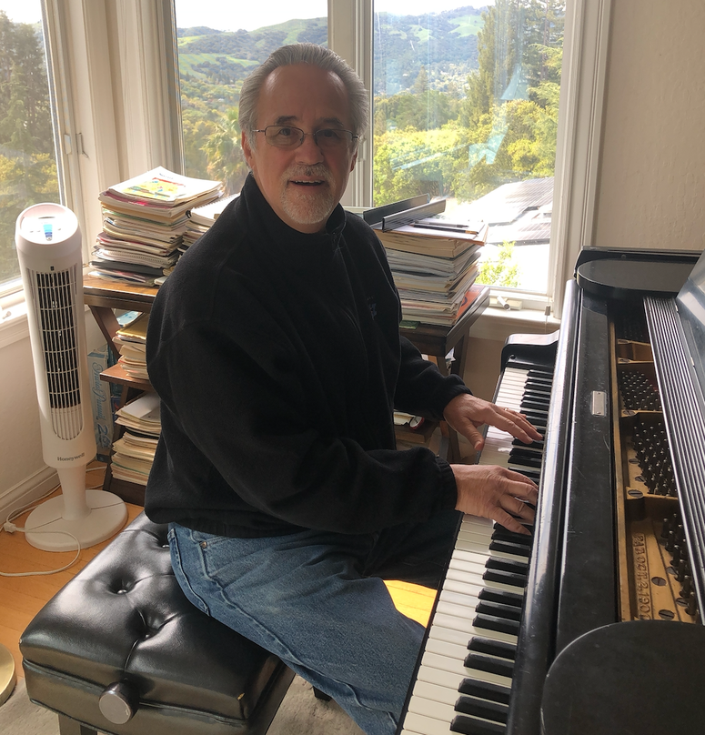 Bob Athayede sits at his piano. Bob Athayede sits at his piano.
