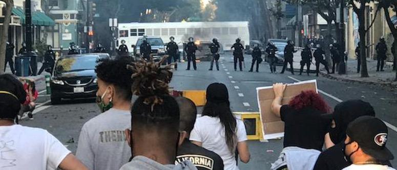 A line of protesters face a line of San Jose Police officers during a demonstration over the death of George Floyd. A line of protesters face a line of San Jose Police officers during a demonstration over the death of George Floyd.