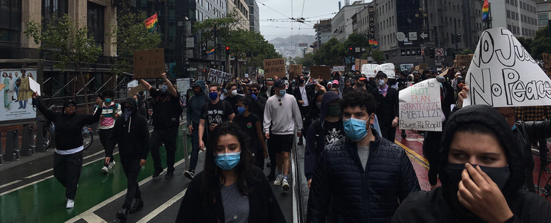 Protesters march down Market St. towards The Embarcadero. Protesters march down Market St. towards The Embarcadero.