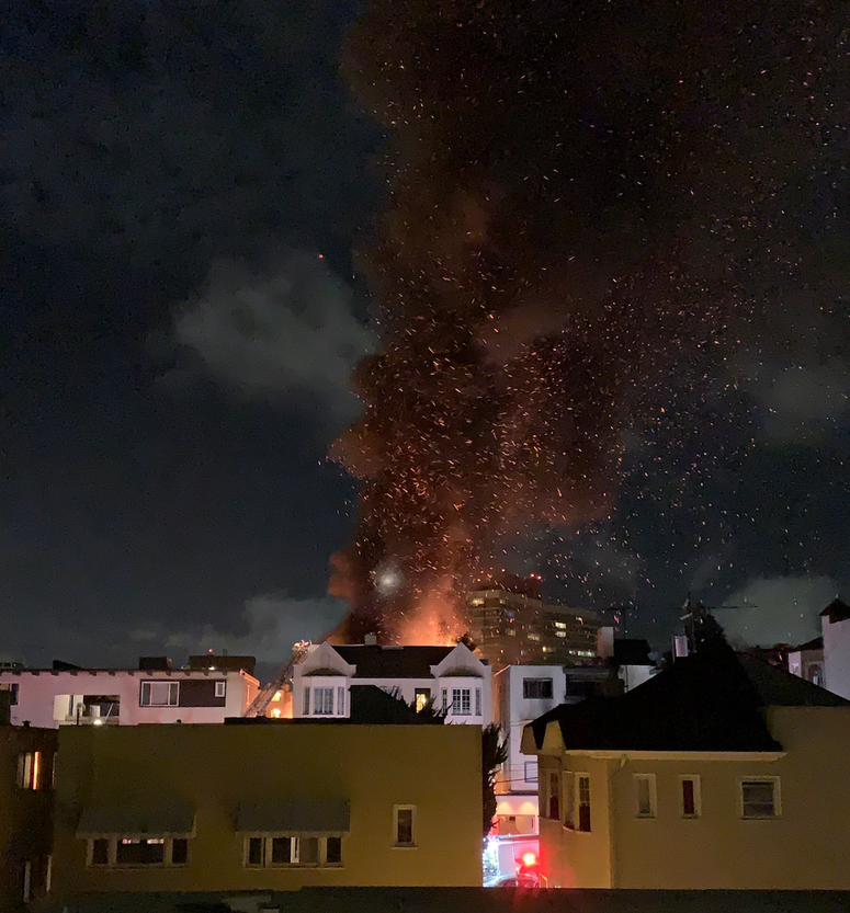 A fire at an apartment building in Oakland on Sunday night seen from a short distance away. A fire at an apartment building in Oakland on Sunday night seen from a short distance away.