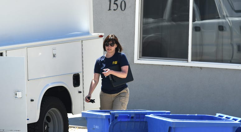 A member of an FBI evidence response team walks in front of a Walker Lake, Nevada apartment building associated with Santino William Legan, a 19-year-old suspected of opening fire at the Gilroy Garlic Festival in California the day before. A member of an FBI evidence response team walks in front of a Walker Lake, Nevada apartment building associated with Santino William Legan, a 19-year-old suspected of opening fire at the Gilroy Garlic Festival in California the day before.