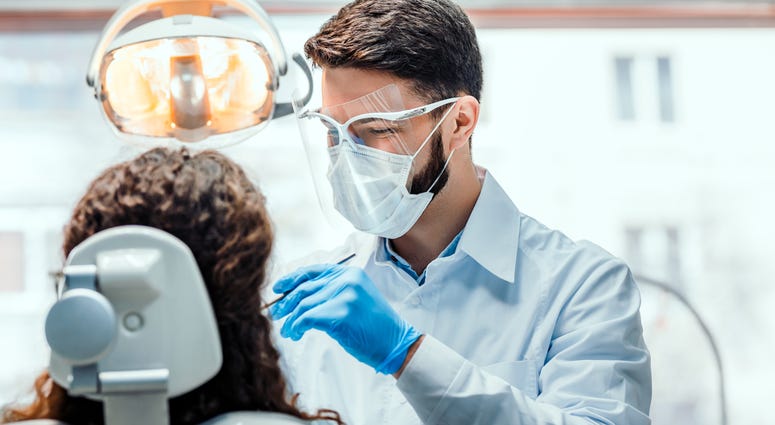 Dentist treats patient