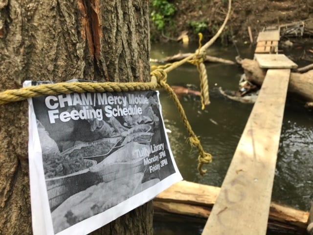 A flier posted by CHAM Deliverance Ministry volunteers on a tree next to San Jose's Coyote Creek to inform those who live in nearby homeless encampments when food distributions will take place A flier posted by CHAM Deliverance Ministry volunteers on a tree next to San Jose's Coyote Creek to inform those who live in nearby homeless encampments when food distributions will take place