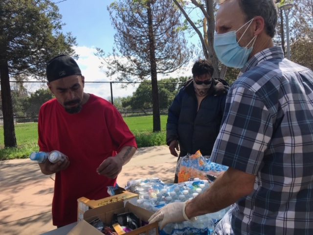 CHAM Deliverance Ministry volunteer Rick Crawford manning the food table during a distribution to homeless residents living near the Tully Community Branch Library in San Jose CHAM Deliverance Ministry volunteer Rick Crawford manning the food table during a distribution to homeless residents living near the Tully Community Branch Library in San Jose