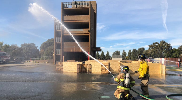 Firefighters demonstrate skills at the Contra Costa County Fire Protection District academy.