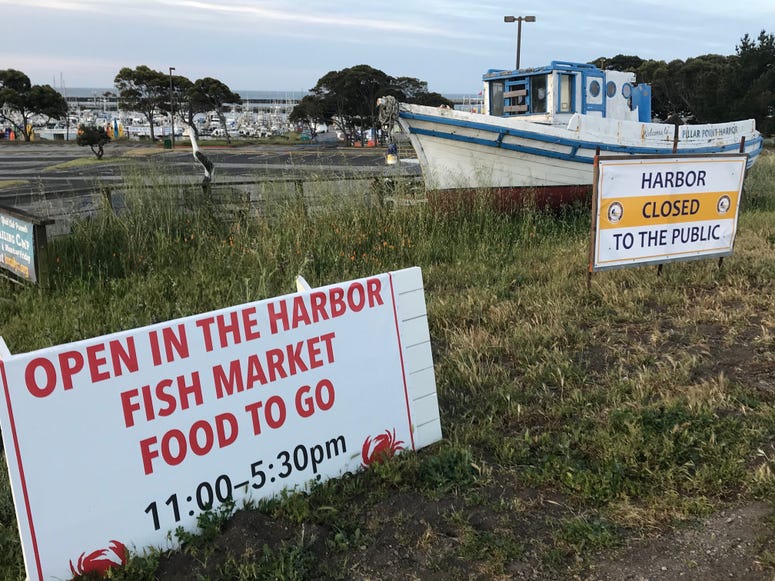 Conflicting signs at Pillar Point Harbor in Half Moon Bay, which has closed due to coronavirus Conflicting signs at Pillar Point Harbor in Half Moon Bay, which has closed due to coronavirus