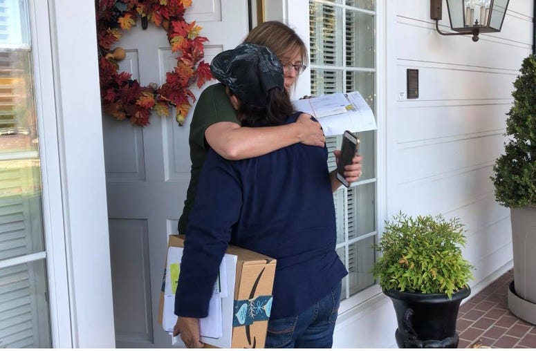 Postal worker Bernadette Laos embraces a customer on her route in Sonoma County. Laos' home was destroyed by the Kincade Fire. Postal worker Bernadette Laos embraces a customer on her route in Sonoma County. Laos' home was destroyed by the Kincade Fire.