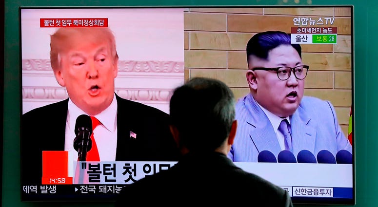 FILE - In this March 27, 2018, file photo, a man watches a TV screen showing file footages of U.S. President Donald Trump, left, and North Korean leader Kim Jong Un during a news program at the Seoul Railway Station in Seoul, South Korea. A Trump administ