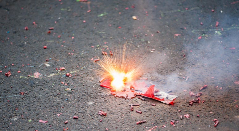 Firecracker exploding in the street Firecracker exploding in the street