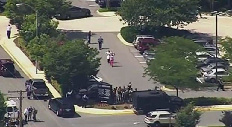 AP18179698434196 In this frame from video, people leave the Capital Gazette newspaper after multiple people have been shot on Thursday, June 28, 2018, in Annapolis, Md. (WJLA via AP)