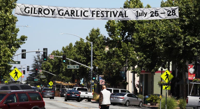 A man walks beneath a sign advertising the nearby Gilroy Garlic Festival after a mass shooting took place at the event yesterday on July 29, 2019 in Gilroy, California. A man walks beneath a sign advertising the nearby Gilroy Garlic Festival after a mass shooting took place at the event yesterday on July 29, 2019 in Gilroy, California.