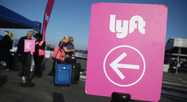 Arriving passengers wait to board Lyft vehicles at the new 'LAX-it' ride-hail passenger pickup lot at Los Angeles International Airport (LAX) on November 6, 2019. Arriving passengers wait to board Lyft vehicles at the new 'LAX-it' ride-hail passenger pickup lot at Los Angeles International Airport (LAX) on November 6, 2019.