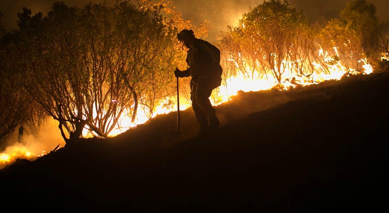 Nov. 14, 2018; Butte County, CA, USA; Firefighters hold a line in the Camp Fire with a control burn near Bloomer Hill in Butte County in California. Wildfire 1