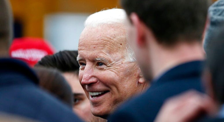 Former vice president Joe Biden talks with officials after speaking at a rally in support of striking Stop & Shop workers in Boston, Thursday, April 18, 2019. AP DO NOT USE
