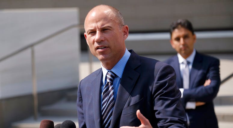 ile photo, attorney Michael Avenatti replies to questions by reporters during a news conference in front of the U.S. Federal Courthouse in Los Angeles. DO NOT USE
