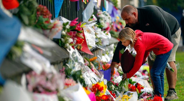 Mourners lay flowers on a wall at the Botanical Gardens in Christchurch, New Zealand, Saturday, March 16, 2019. Mourners lay flowers on a wall at the Botanical Gardens in Christchurch, New Zealand, Saturday, March 16, 2019.