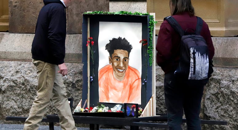 Passers-by looks at a memorial display with a drawing of Antwon Rose II in front of the Allegheny County courthouse on the second day of the trial for Michael Rosfeld, a former police officer in East Pittsburgh Passers-by looks at a memorial display with a drawing of Antwon Rose II in front of the Allegheny County courthouse on the second day of the trial for Michael Rosfeld, a former police officer in East Pittsburgh