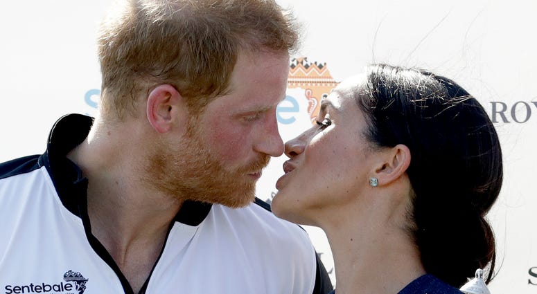 Meghan, Duchess of Sussex and Britain's Prince Harry kiss Meghan, Duchess of Sussex and Britain's Prince Harry kiss